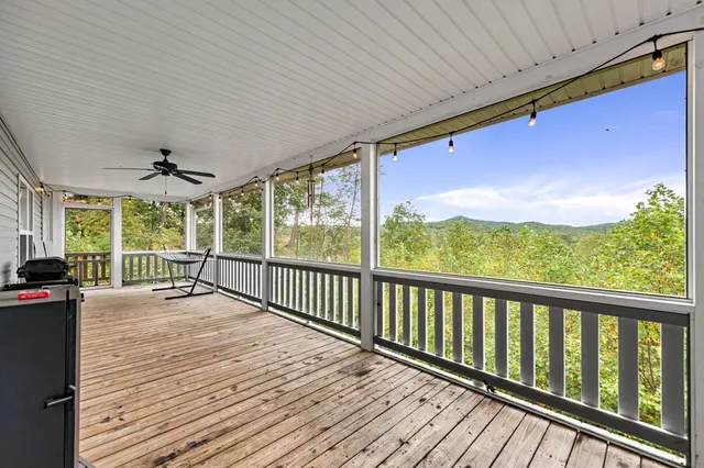 a view of a patio with wooden floor and iron stairs