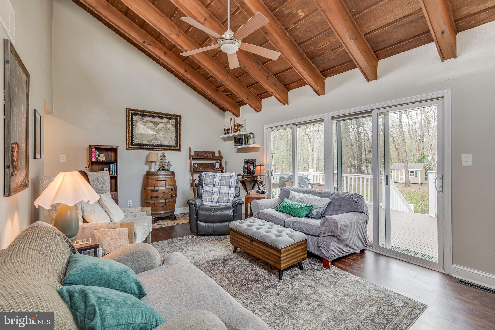 407 Indian Mills Road Shamong, NJ 08088 - Photo 12 of 39 a living room with furniture and a floor to ceiling window