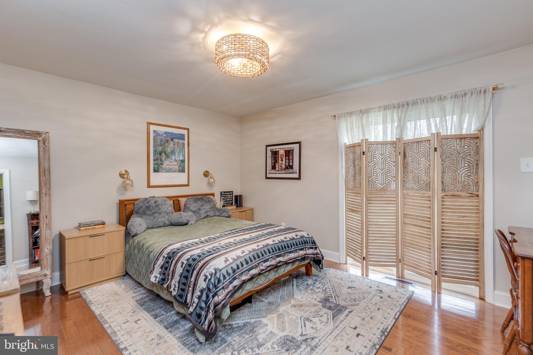 407 Indian Mills Road Shamong, NJ 08088 - Photo 20 of 39 a bedroom with a bed and a chandelier