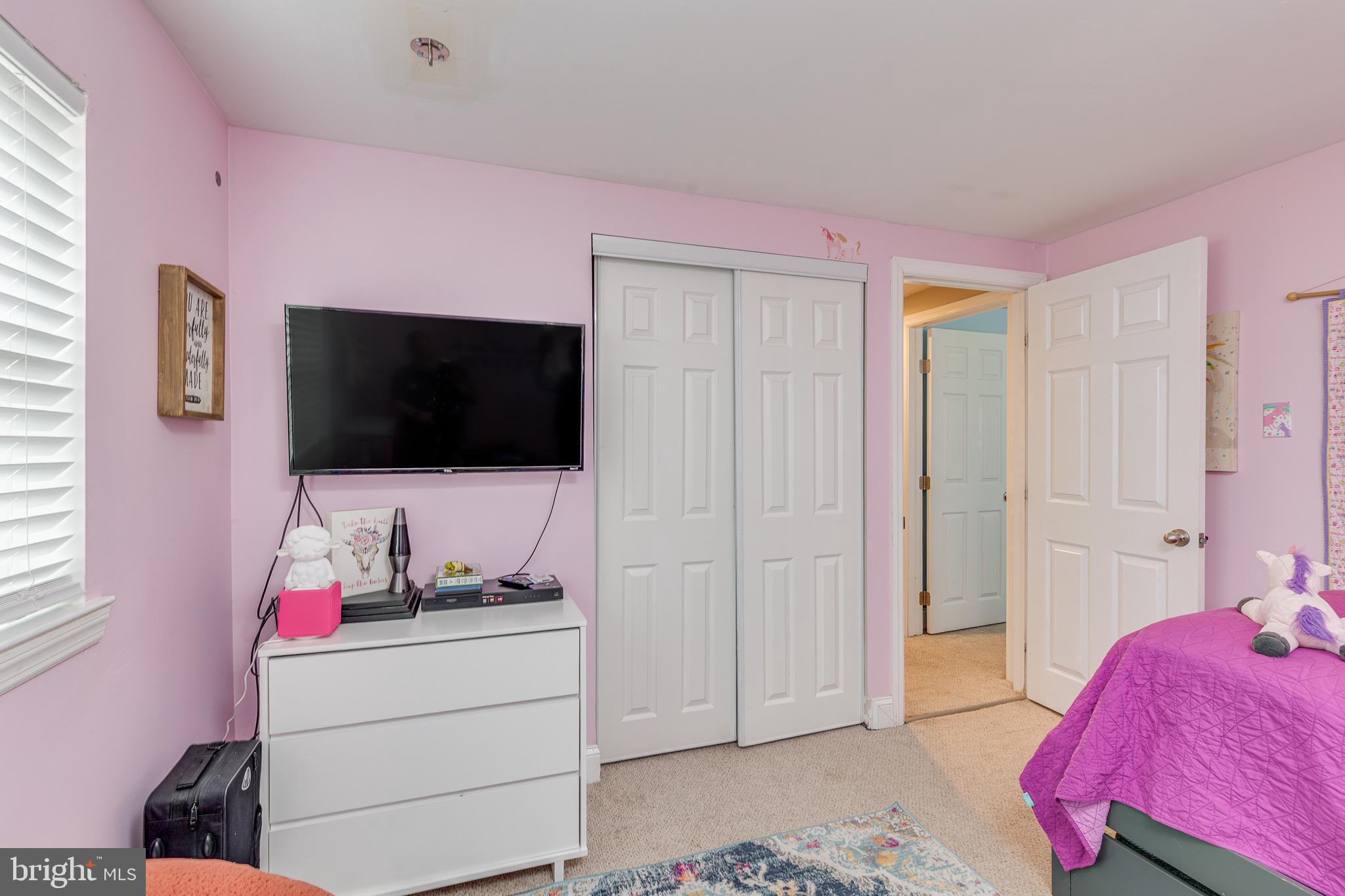 407 Indian Mills Road Shamong, NJ 08088 - Photo 33 of 39 a living room with a flat screen tv on dresser and a window