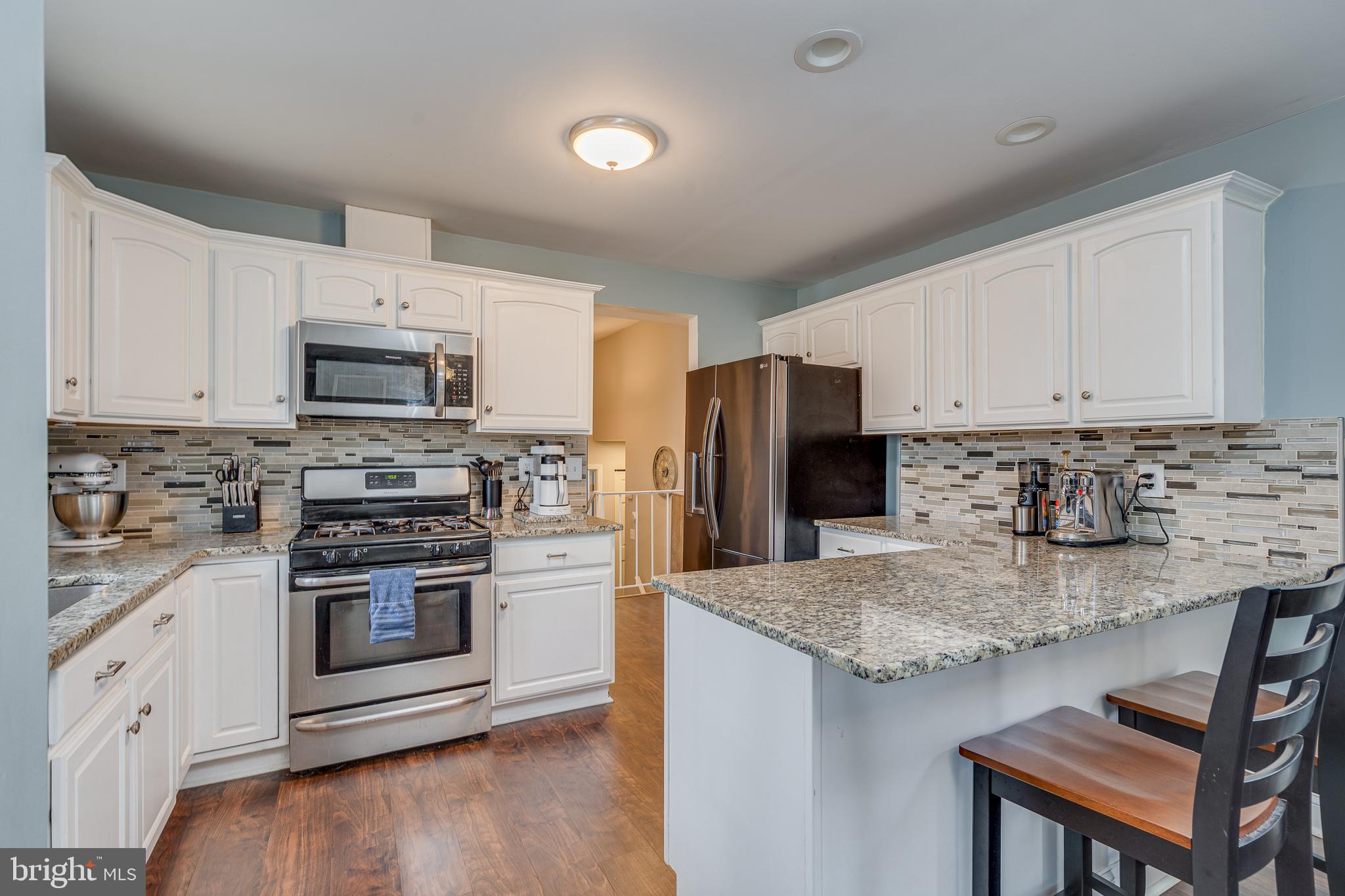 407 Indian Mills Road Shamong, NJ 08088 - Photo 4 of 39 a kitchen with stainless steel appliances granite countertop a stove a sink a refrigerator a microwave and cabinets