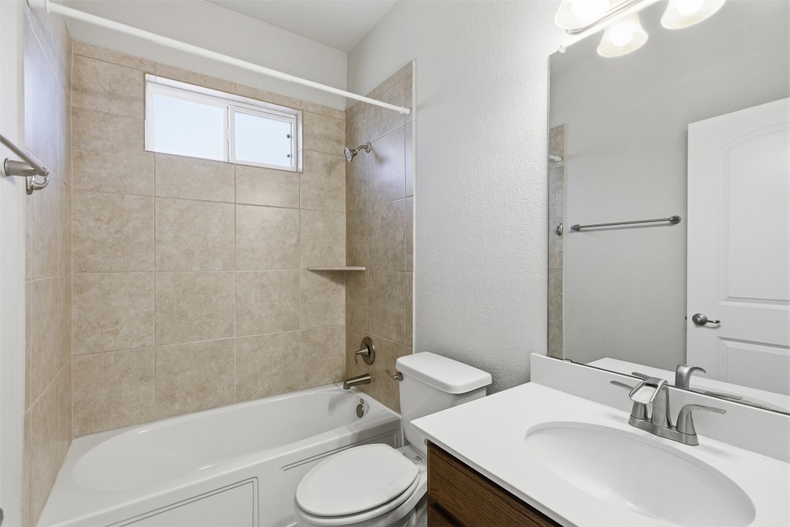 3451 Mayfield Ranch Boulevard, Unit 369 Round Rock, TX 78681 - Photo 21 of 29 Full bathroom featuring vanity, shower / bathtub combination, and a textured wall