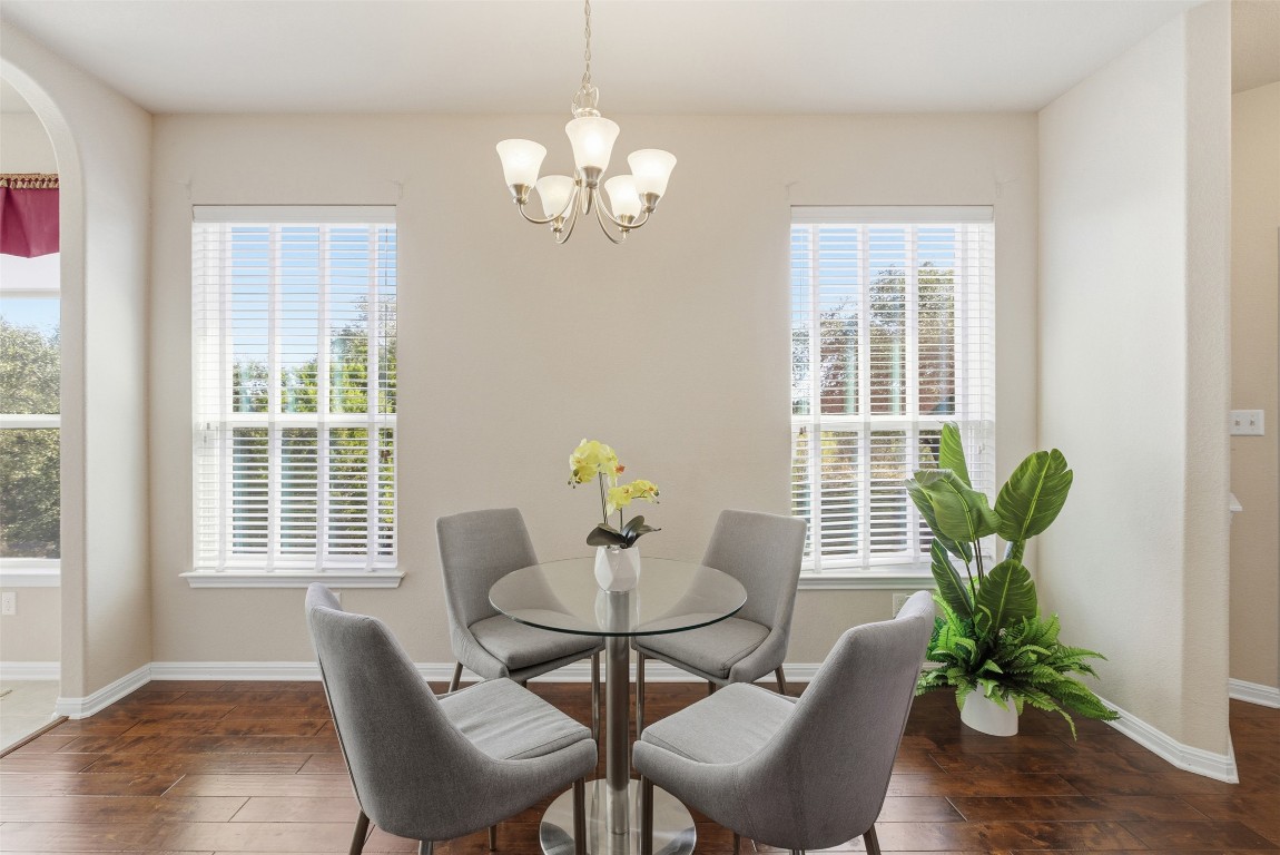 3451 Mayfield Ranch Boulevard, Unit 369 Round Rock, TX 78681 - Photo 9 of 29 Dining area featuring dark wood-type flooring and a chandelier