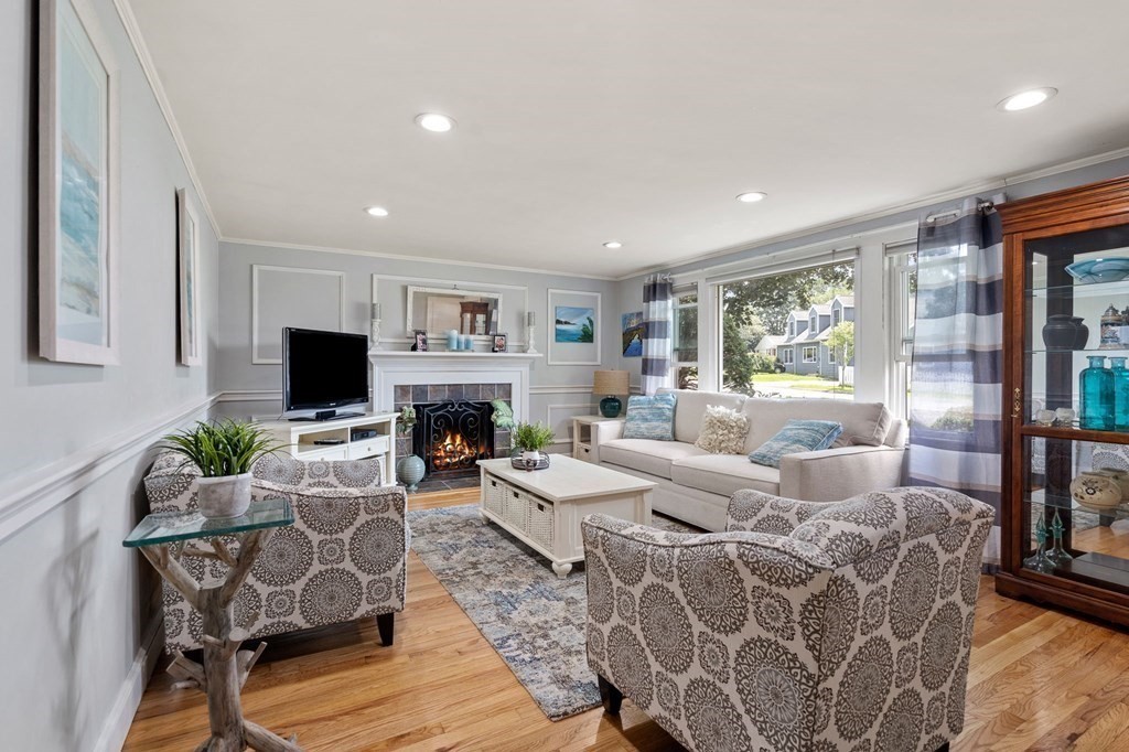 20 Sheffield Road Danvers, MA 01923 - Photo 13 of 38 a living room with furniture a flat screen tv and a fireplace