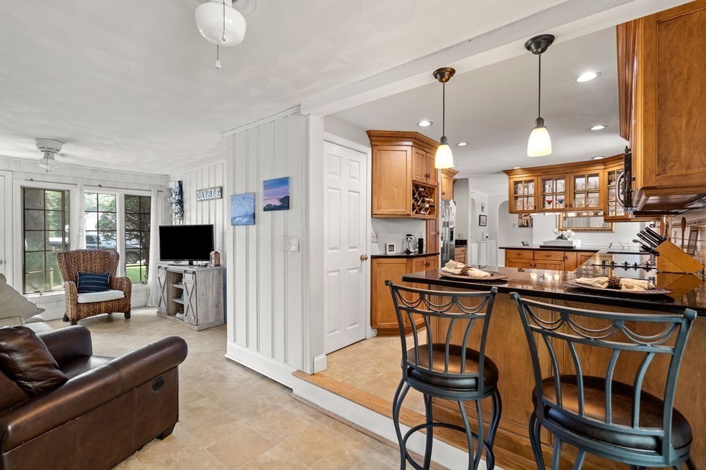 20 Sheffield Road Danvers, MA 01923 - Photo 6 of 38 a kitchen island with stainless steel appliances kitchen island granite countertop a table and chairs in it