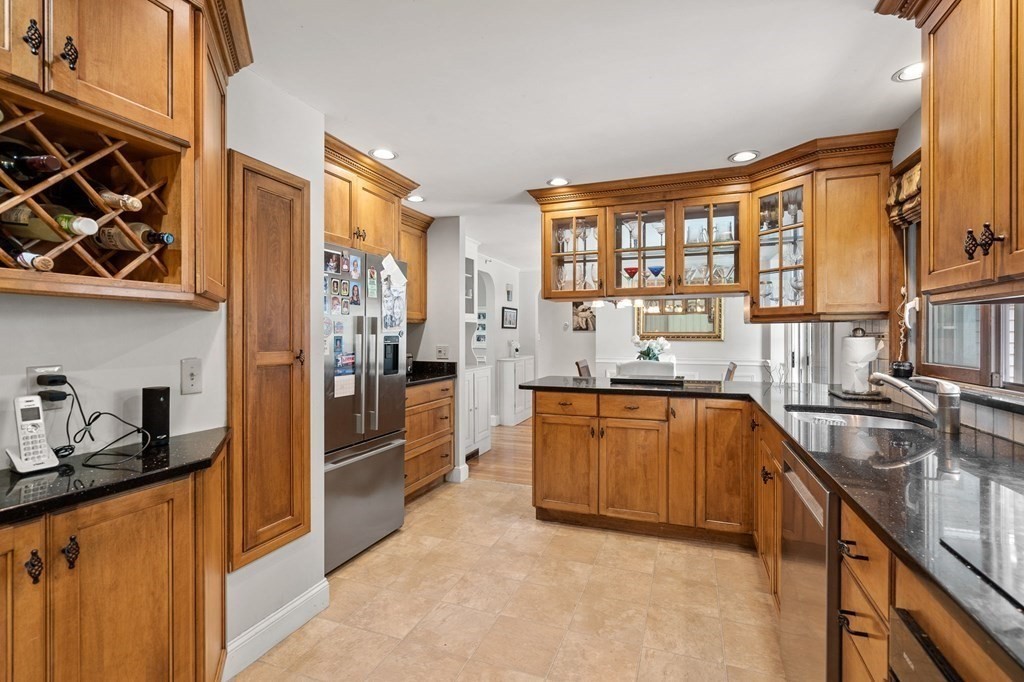 20 Sheffield Road Danvers, MA 01923 - Photo 7 of 38 a kitchen with stainless steel appliances granite countertop a refrigerator and a stove top oven