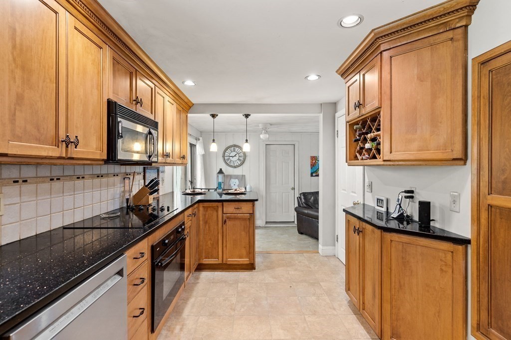 20 Sheffield Road Danvers, MA 01923 - Photo 8 of 38 a kitchen with stainless steel appliances granite countertop a sink stove refrigerator and cabinets