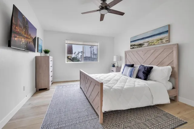 a bed room with a bed and a painting on the wall