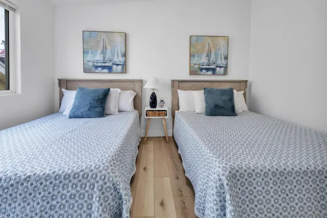 a bed room with a bed and painting on the wall