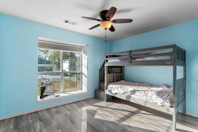 a bedroom with a bed and a large window