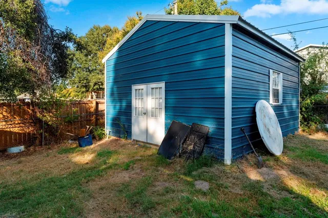 a view of a wooden chairs and bench in the backyard