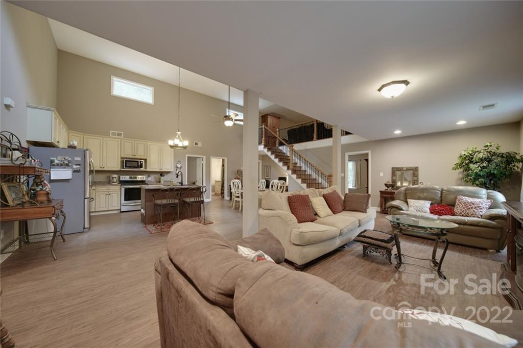 a living room with furniture and kitchen view