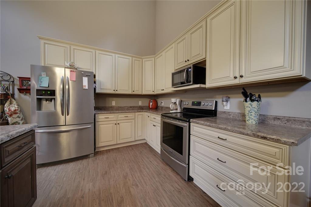 3579 Harmony Road Catawba, SC 29704 - Photo 11 of 48 a kitchen with stainless steel appliances granite countertop a refrigerator stove and white cabinets