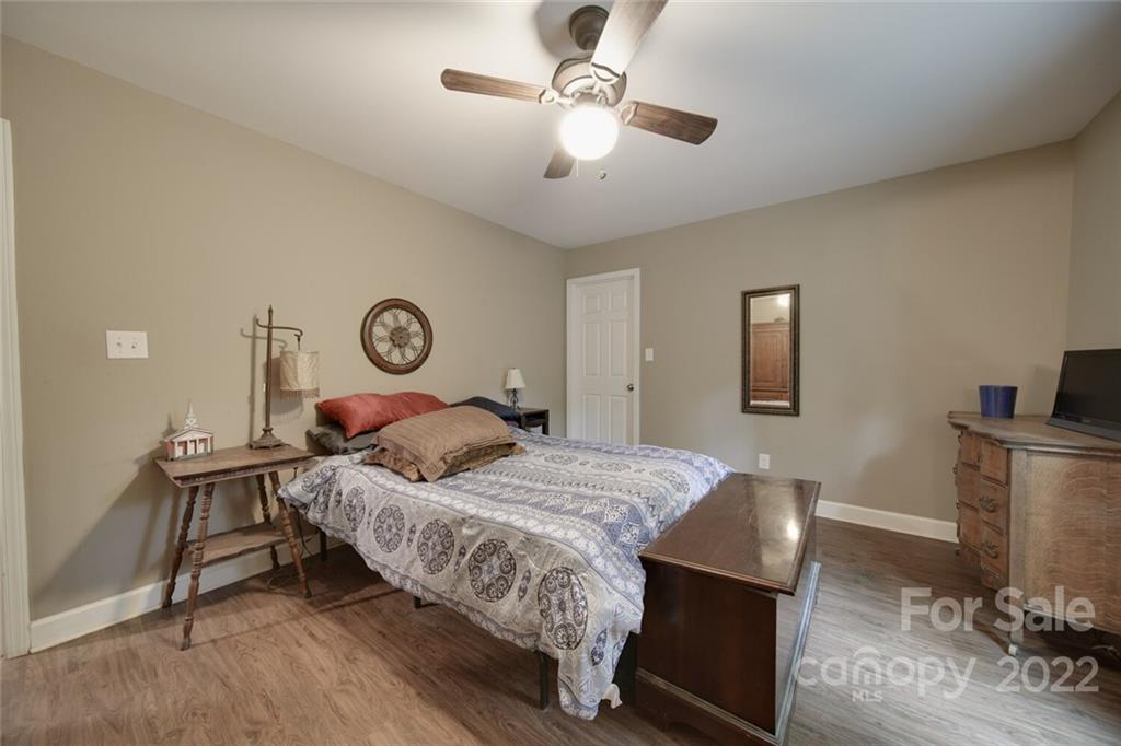 3579 Harmony Road Catawba, SC 29704 - Photo 24 of 48 a bedroom with a bed and a chandelier