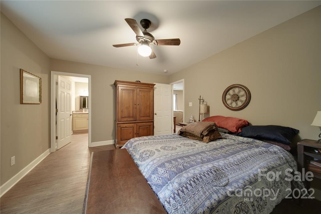 3579 Harmony Road Catawba, SC 29704 - Photo 25 of 48 a bedroom with a bed and a chandelier
