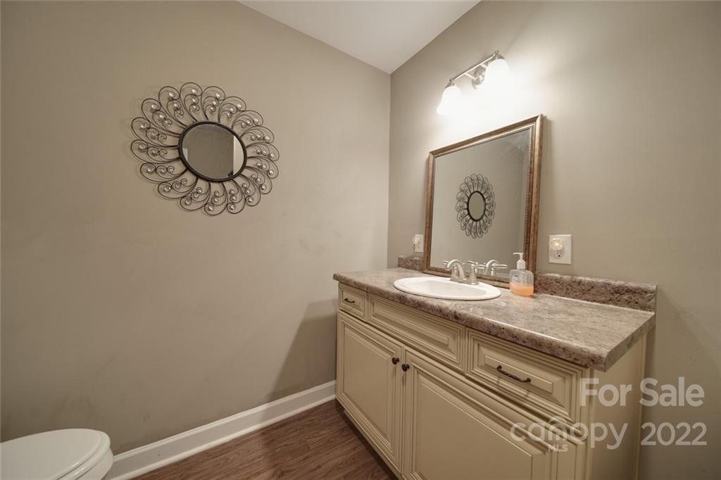3579 Harmony Road Catawba, SC 29704 - Photo 31 of 48 a bathroom with a granite countertop sink and a mirror