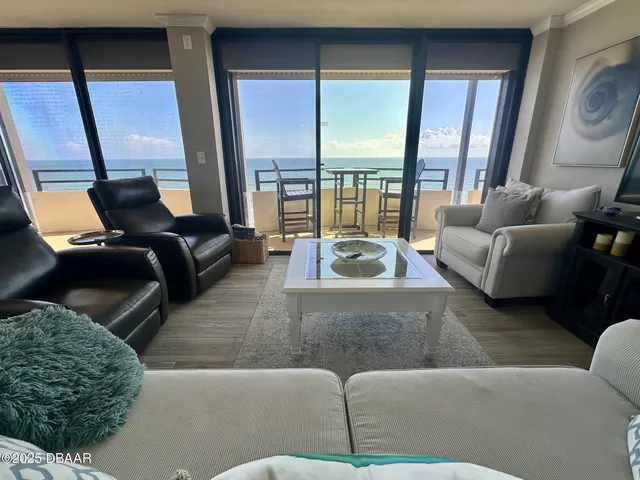 a living room with furniture and large windows