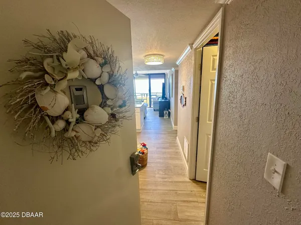 a hallway with a dining table and chairs
