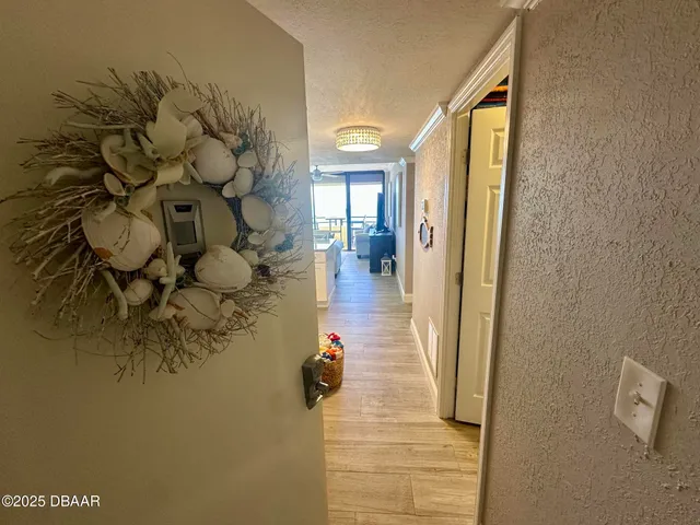 a hallway with a dining table and chairs