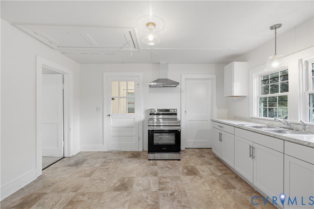 239 Brunswick Road Emporia, VA 23847 - Photo 17 of 22 Bright kitchen featuring white cabinetry, a stainl