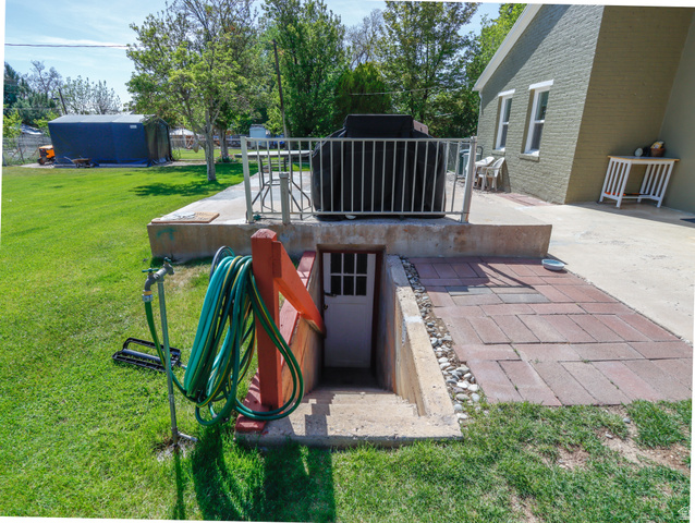155 West Center Street Fillmore, UT 84631 - Photo 61 of 86 Exterior basement access featuring concrete steps, a white door, and a red-painted wooden railing