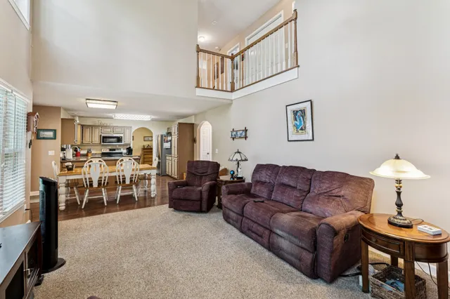 a living room with furniture a ceiling fan and a window