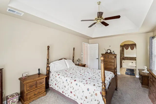 a bedroom with a bed and dresser