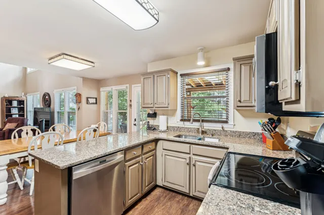 a kitchen with a sink stove and cabinets