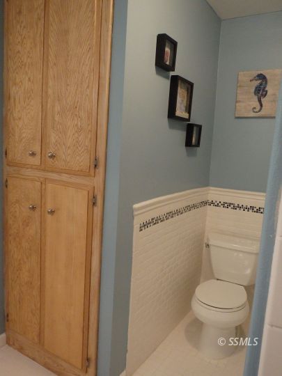 723 West Kevin Court Ridgecrest, CA 93555 - Photo 17 of 48 a white toilet sitting next to a shower curtain