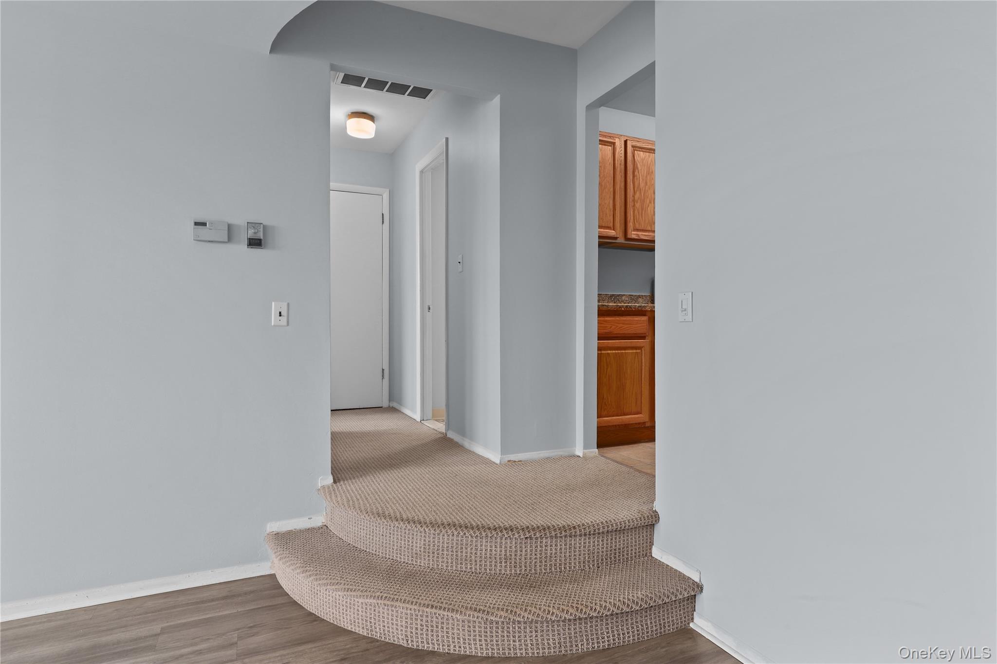 60 Kensico Road, Unit 22 Thornwood, NY 10594 - Photo 2 of 14 a view of a hallway with wooden floor and staircase