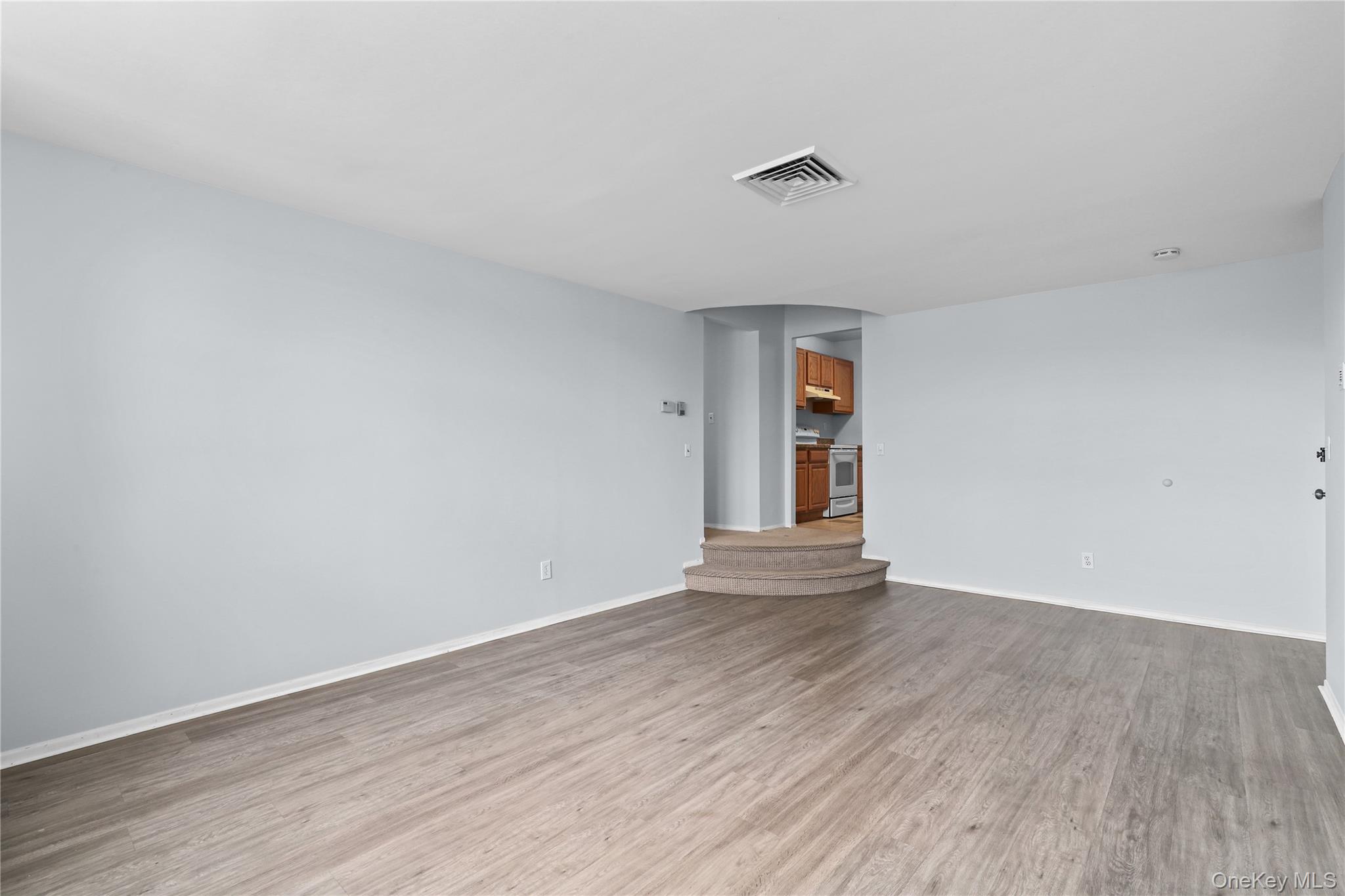 60 Kensico Road, Unit 22 Thornwood, NY 10594 - Photo 4 of 14 an empty room with wooden floor and windows