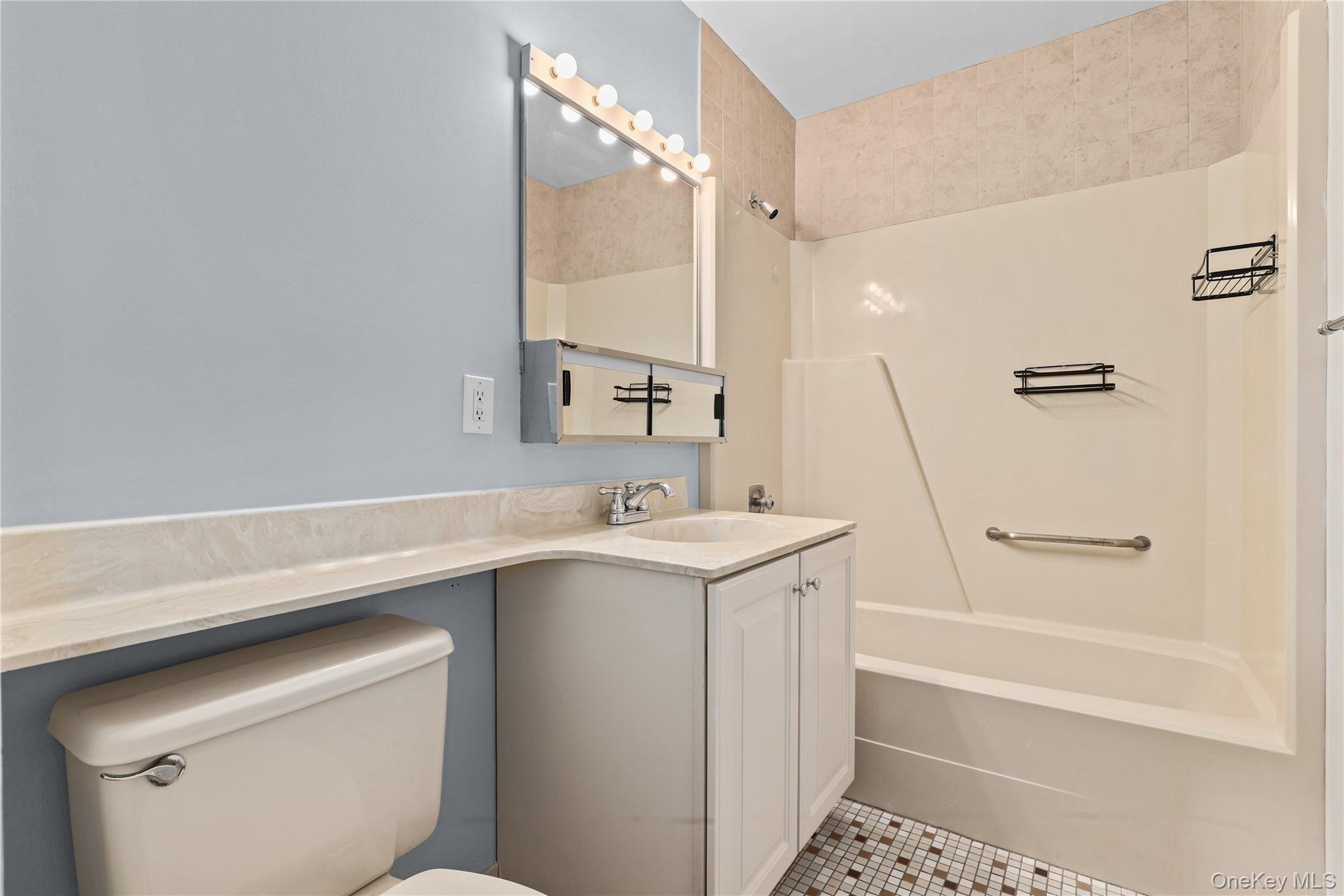 60 Kensico Road, Unit 22 Thornwood, NY 10594 - Photo 5 of 14 a bathroom with a sink a toilet and a bathtub