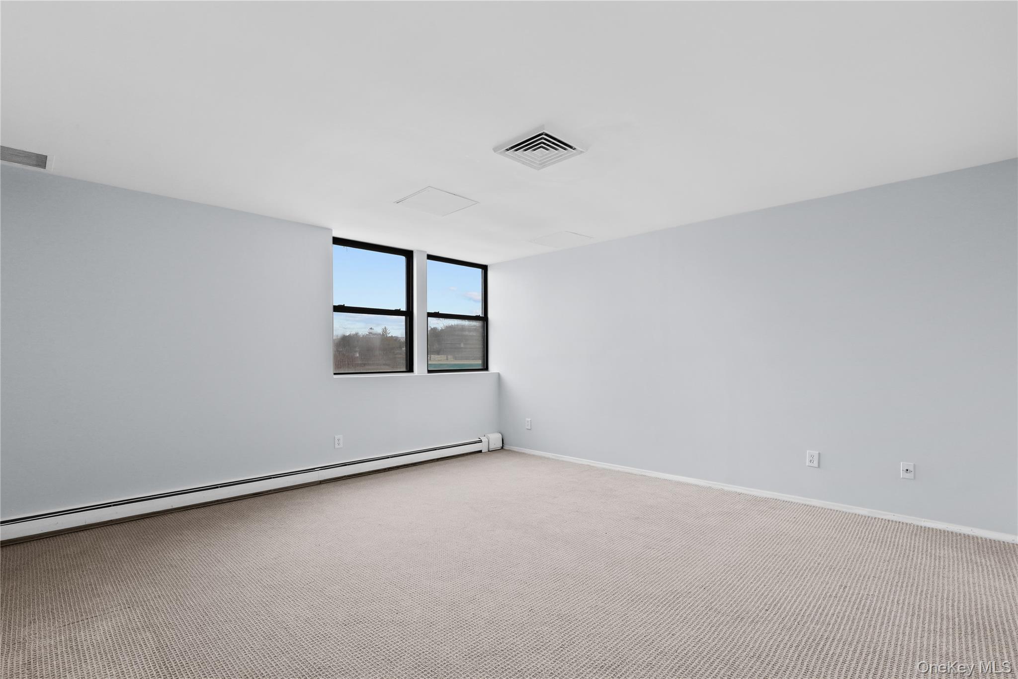 60 Kensico Road, Unit 22 Thornwood, NY 10594 - Photo 8 of 14 an empty room with windows and closet