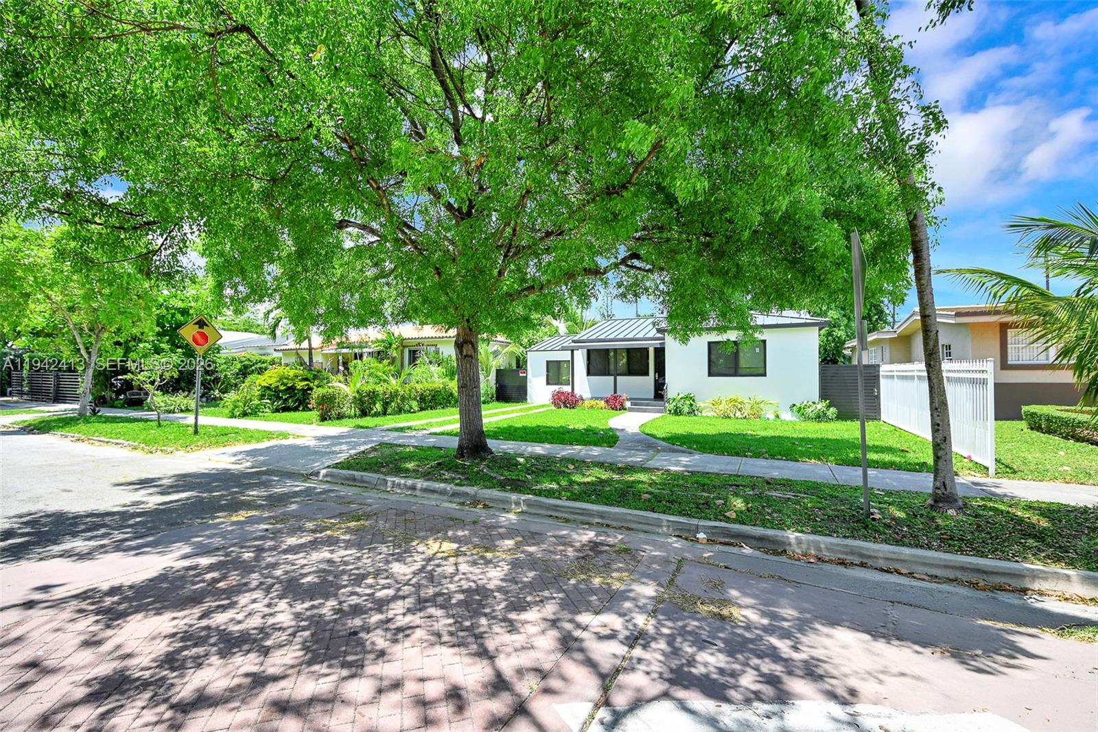 2261 Southwest 26th Street Miami, FL 33133 - Photo 2 of 12 a view of a house with a big yard and large trees