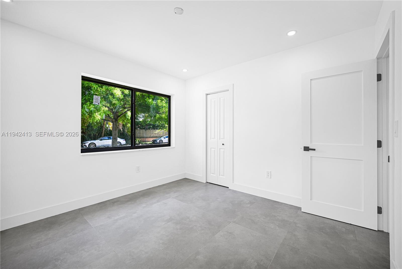 2261 Southwest 26th Street Miami, FL 33133 - Photo 6 of 12 a view of an empty room with a window