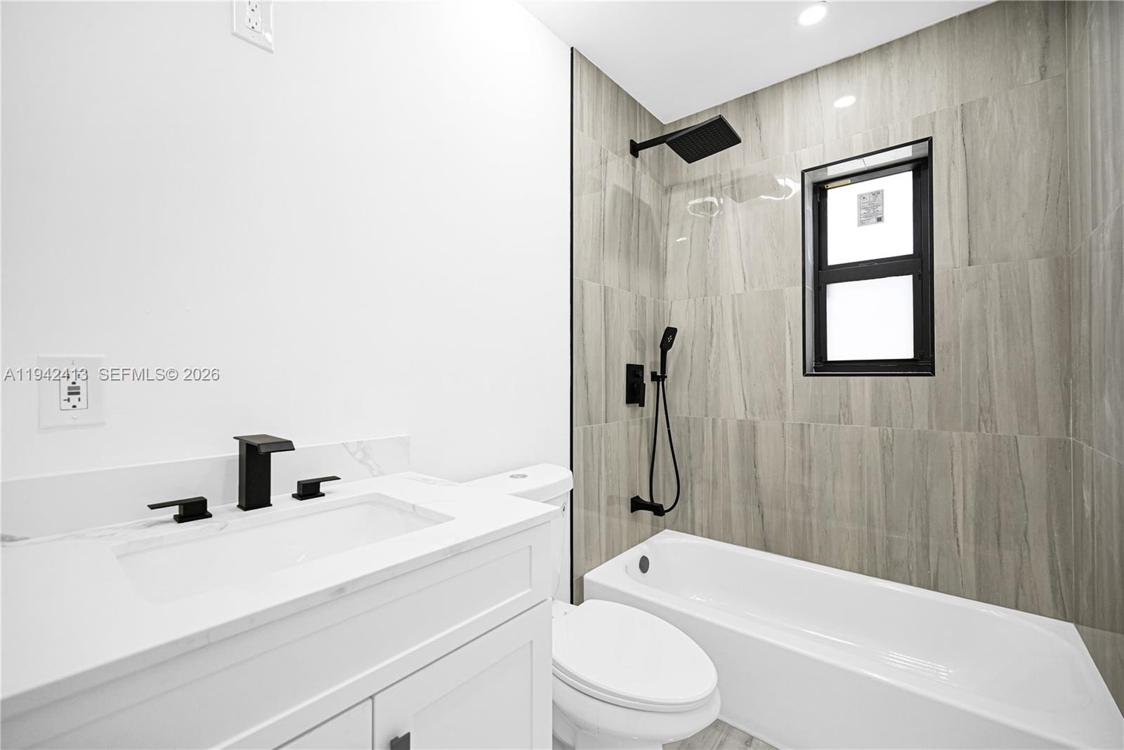 2261 Southwest 26th Street Miami, FL 33133 - Photo 7 of 12 a bathroom with a sink a toilet and shower