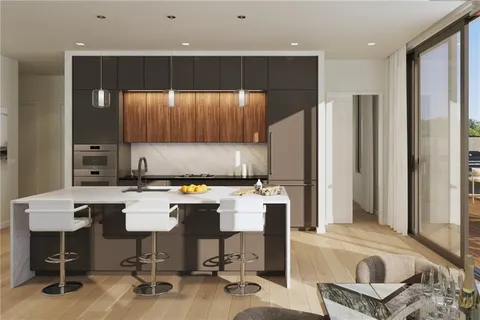 a kitchen with a table chairs refrigerator and cabinets
