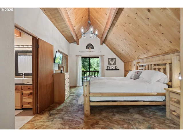 a bedroom with a bed next to a window with outer view