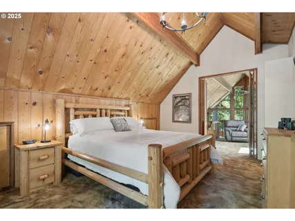 a bedroom with a bed next to a window with the outer view