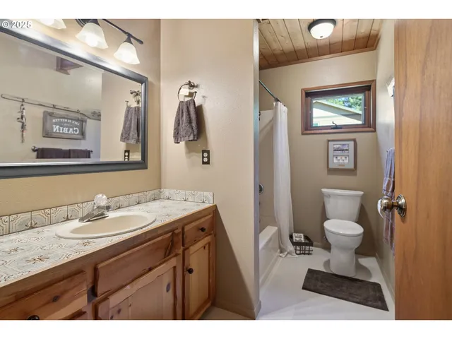 a bathroom with a toilet a sink and mirror