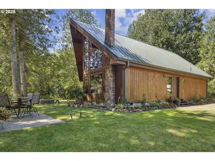 a backyard of a house with table and chairs