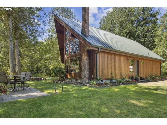 a backyard of a house with table and chairs