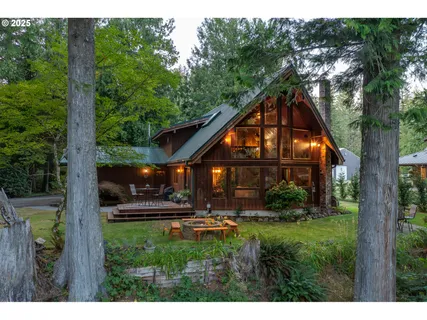 a view of a house with backyard and sitting area