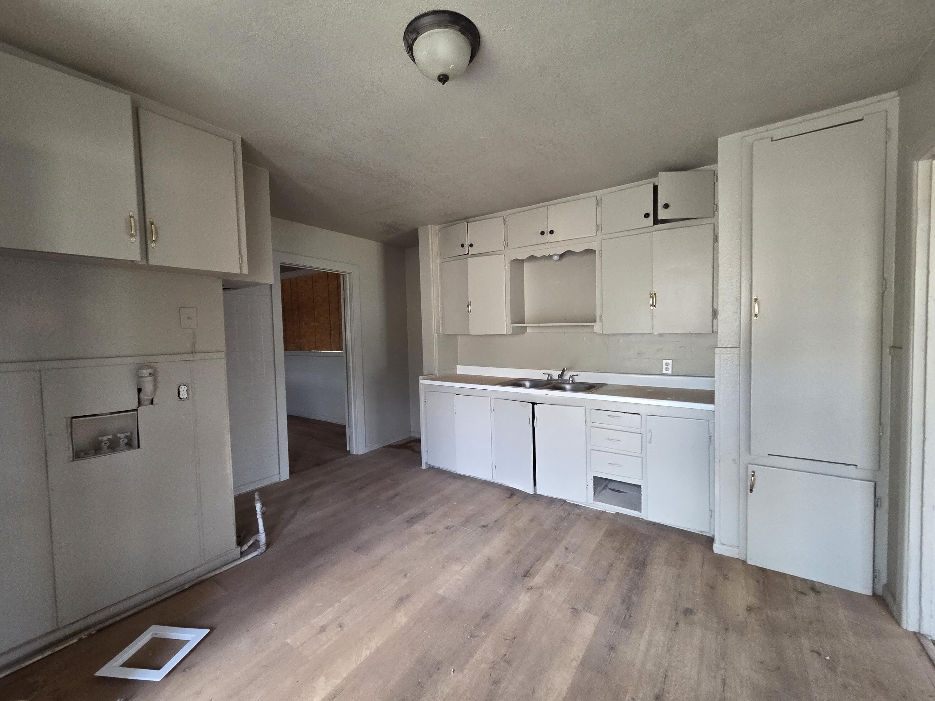 4-properties 4-properties Fixer Package Lubbock, TX 79403 - Photo 2 of 39 a kitchen with granite countertop a refrigerator a sink and white cabinets
