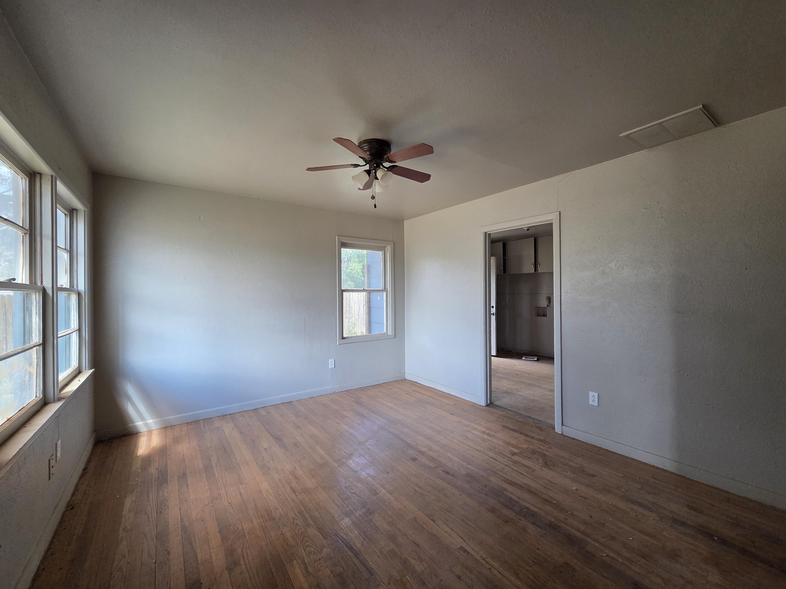 4-properties 4-properties Fixer Package Lubbock, TX 79403 - Photo 3 of 39 wooden floor in an empty room with a window