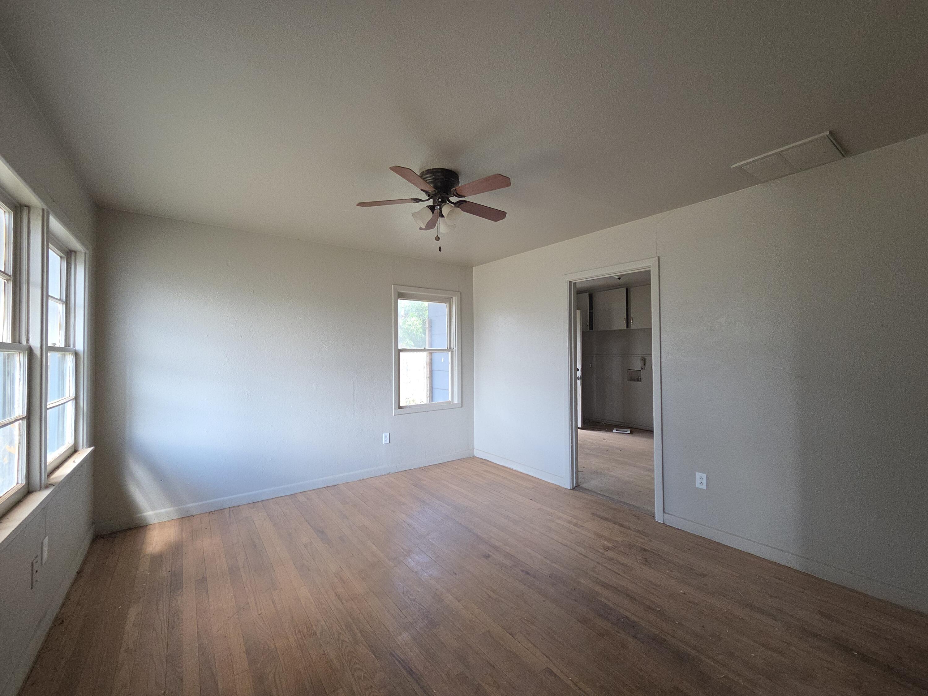 4-properties 4-properties Fixer Package Lubbock, TX 79403 - Photo 4 of 39 wooden floor in an empty room with a window