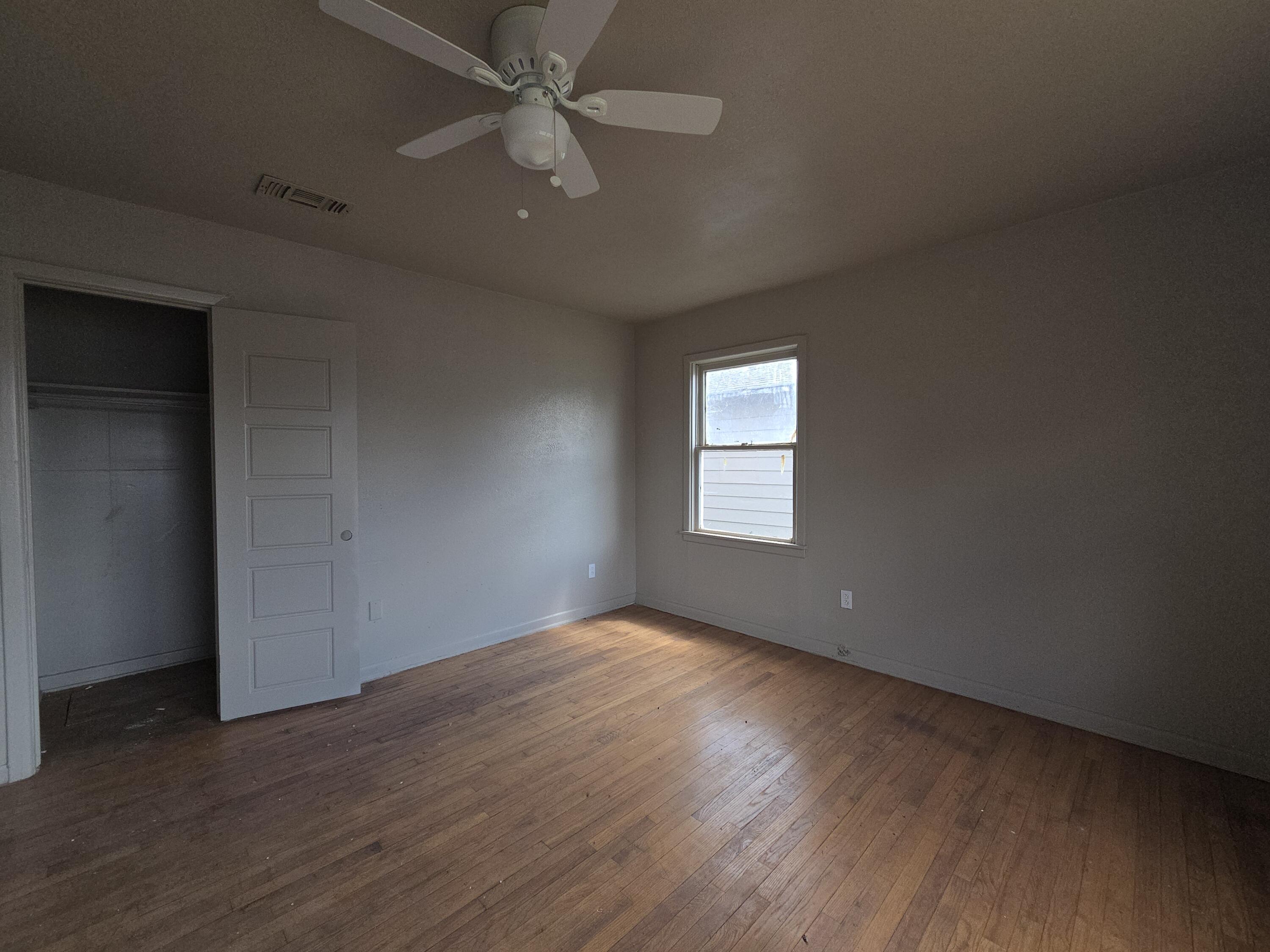 4-properties 4-properties Fixer Package Lubbock, TX 79403 - Photo 5 of 39 an empty room with wooden floor fan and windows