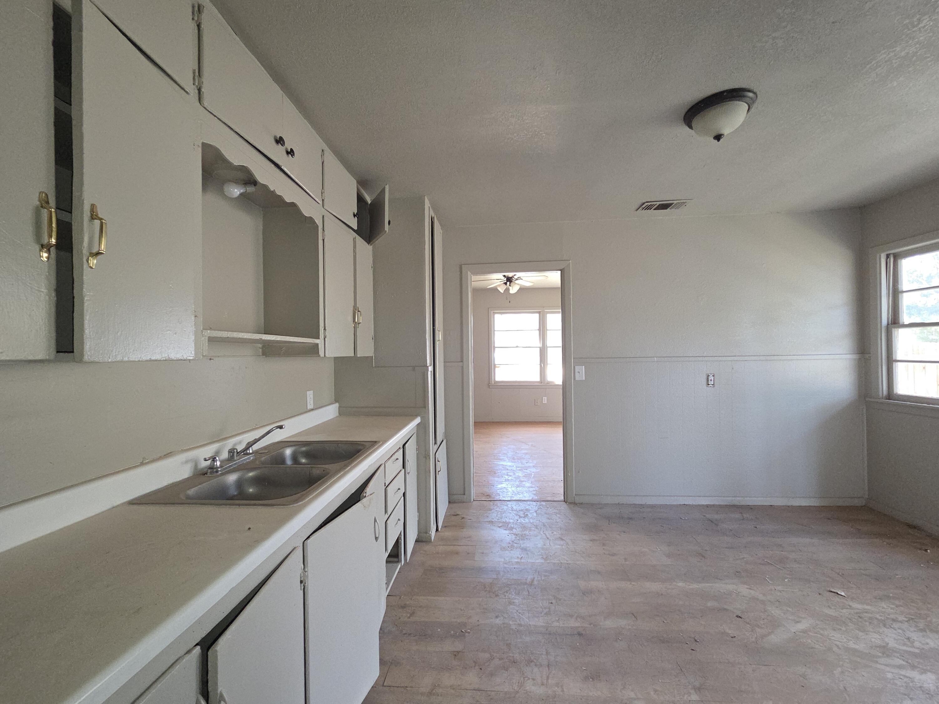 4-properties 4-properties Fixer Package Lubbock, TX 79403 - Photo 8 of 39 a kitchen with a sink stove and cabinets