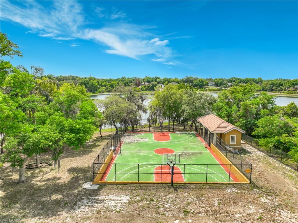 4200 South Hiawassee Road Orlando, FL 32835 - Photo 42 of 47 a view of a tennis ground with large trees