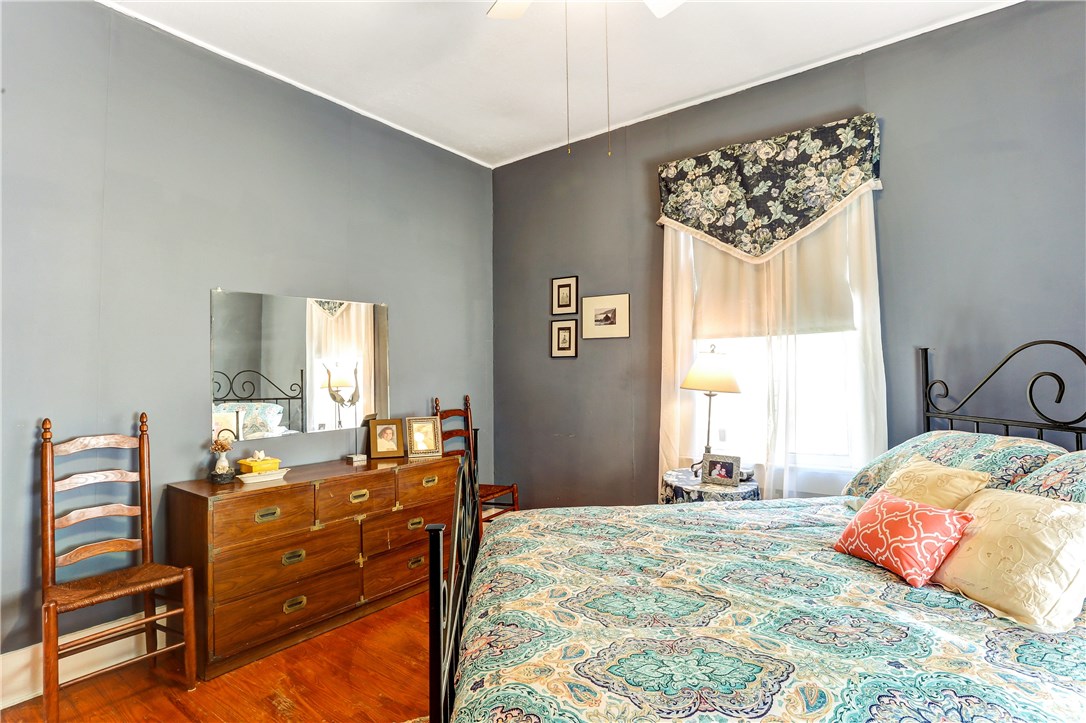 603 Broome Street Fernandina Beach, FL 32034 - Photo 21 of 33 a bedroom with a bed and wooden floor